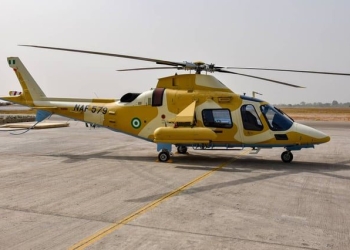 Nigerian Air Force AW-109 helicopter in desert camo and armed configuration.