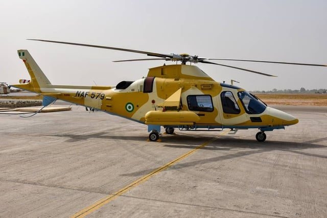 Nigerian Air Force AW-109 helicopter in desert camo and armed configuration.